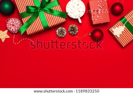 Gift boxes, Christmas balls, toys, fir cones, ribbon on red background. Festive, congratulation, New Year Christmas presents Xmas holiday 2019 greeting card. Flat lay, top view, copy space.