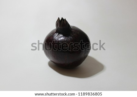 Various close up photos with white background of black skin pomegranate with red inside
