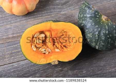 Green pumpkin on a wood background