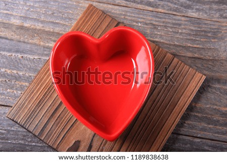 Heart shaped bowl on a wooden background