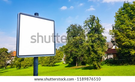 Blank Outdoor Advertisement Billboard Banner Sign with Silver Frame in Park On Beautiful Sunny Day.White Display Isolated Template Clipping Path Free Space Ad Mock Up