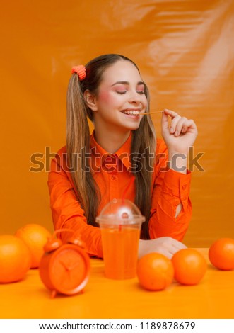 cheerful gum girl on orange background