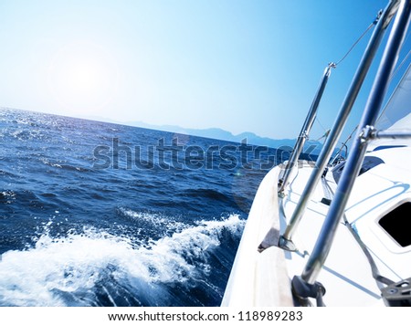 Photo of a 43 foot sailboat in action, speeding at open blue sea, parts of a luxury yacht boat, extreme water sport adventure, freedom and active lifestyle concept