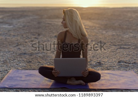 Girl with a laptop outdoors

