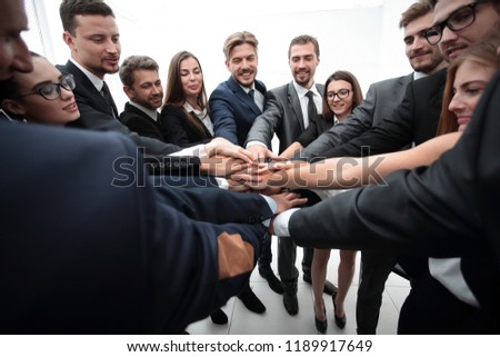 large business team standing with folded hands together