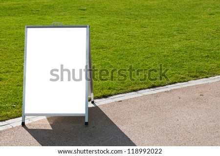 empty metallic board next to a grass field (isolated on white, focus on the grass)