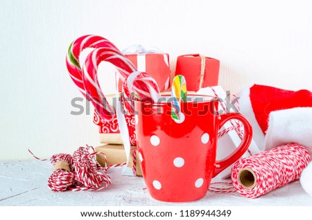Red cup with marshmallows and candy stick, many gifts on the white background. card Holiday Concept. copy space,