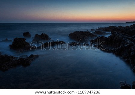 Beautiful landscape and nature photo of sunset at Adriatic Sea in Croatia Europe. Nice colorful outdoors image. Calm, peaceful picture of ocean, rocks and sky at dusk evening.
