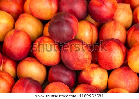 a beautiful fragrant ripe nectarine, the view from the top. Royalty-Free Stock Photo #1189952581