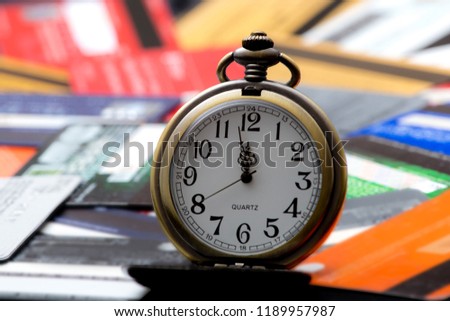 Image took on August 8 ,2018 picture took in studio at Miami, Florida, USA , in photo old fashioned clock and blurred credit cards , giving idea of deadline to pay