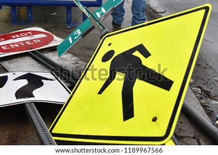 Fallen road signs after a storm on a wet sidewalk in Newark, New Jersey