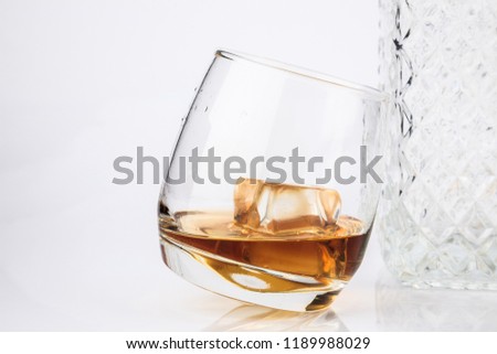 Glass of scotch whiskey and ice isolated on a white background