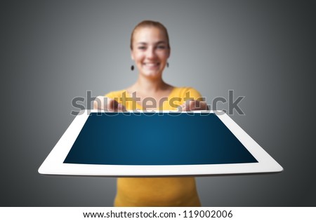 Beautiful young woman holding modern modern tablet