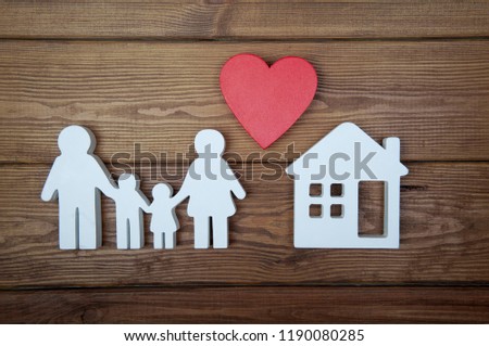 Symbol of family, house and heart on wooden background. Home insurance. Property insurance and security. Health care and insurance concept. Life insurance for whole family. 