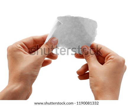 Hands holding a small piece of paper. Close up. Isolated on white background