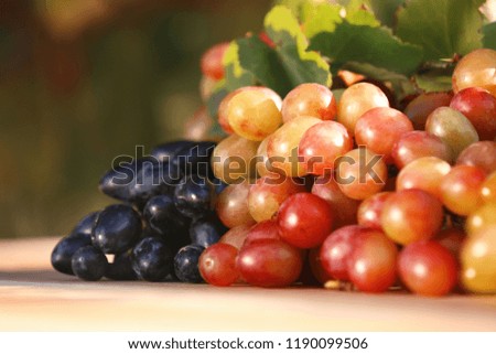 Fresh ripe juicy grapes on table against blurred background