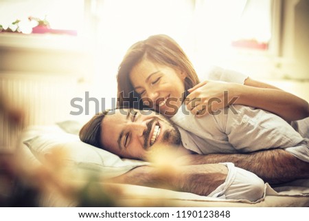 You are my happiness. Happy young couple in bed. Space for copy.