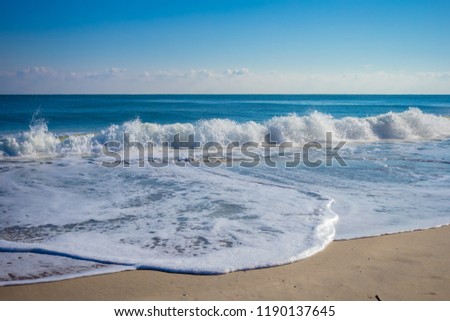 white sand beach meet tropical ocean with small waves with nice blue sky background on sunny day in Summer - Ocean City, Maryland USA Royalty-Free Stock Photo #1190137645
