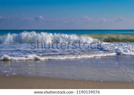 tropical ocean with typical waves and nice blue sky in Summer - Ocean City, Maryland USA Royalty-Free Stock Photo #1190139076