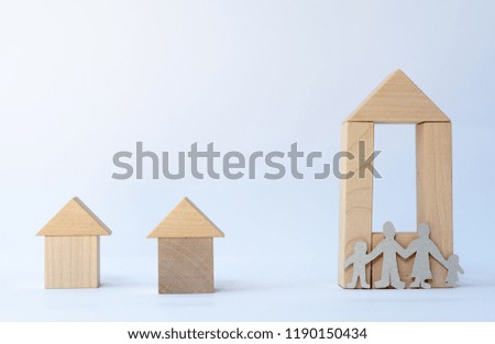 Small wooden house and family around it.