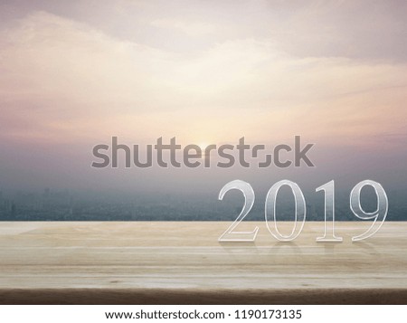 Happy new year 2019 text on wooden table over modern office city tower and skyscraper, vintage style, Business greeting card concept
