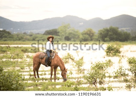Young woman with her horse in evening sunset light. Outdoor photography with fashion model girl. Lifestyle mood