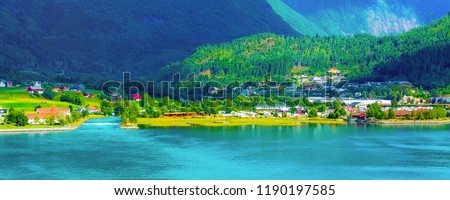 Norwegian village banner landscape with fjord, mountains and colorful houses, church in Olden, Norway
