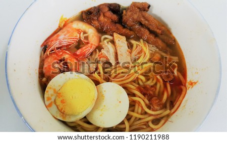 Hokkien mee in white bowl. White background. Top view. Central of picture.