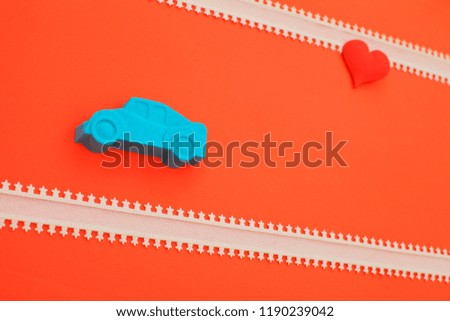 valentines day holidays celebration with kinetic sand car and  heart on red background