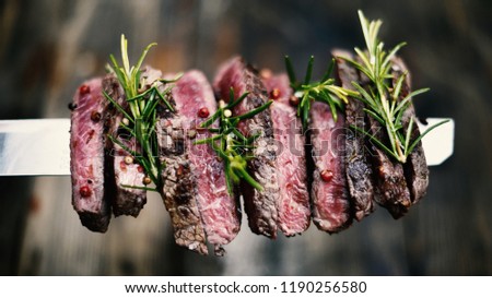 Two barbecue dry aged Kobe roast beef as close-up on a grillage Royalty-Free Stock Photo #1190256580