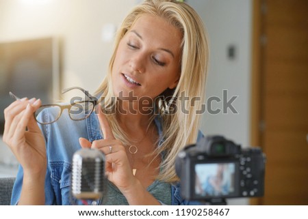 Vlogger woman recording video for her blog