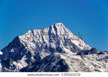 Wild mountain peaks covered with snow on sunny winter day in Dolomites, Bormio region.