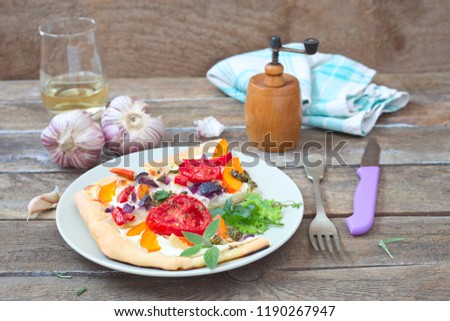 Savory flatbread with tomato, pumpkin, red onion and herbs
