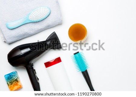 Photo of hair dryer, comb, scissors, towels, soaps isolated on white background.