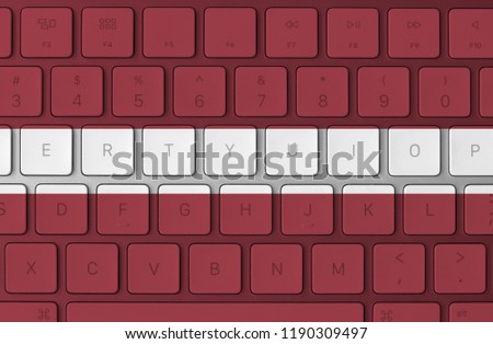 Latvia flag and computer keyboard in the background