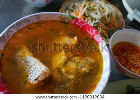 Delicious fish soup with onion tomato chillies sauce herbs pineapple traditional Vietnamese food 