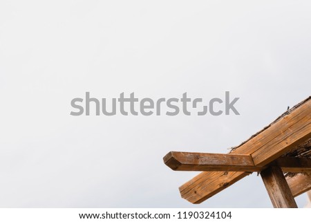 Background of sky and wooden beams of a porch to make shade in summer.