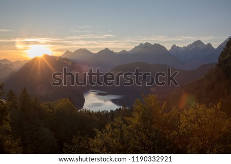 a pic from the alps with mountains rivers trees as landscape