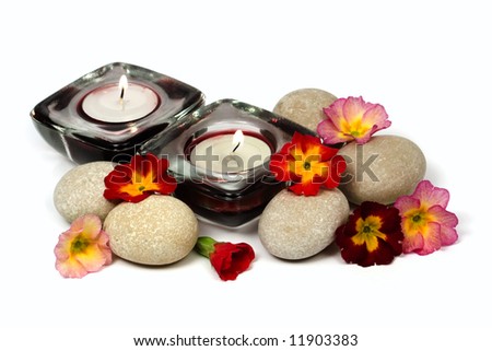 Flowers, stones and scented candles isolated on white
