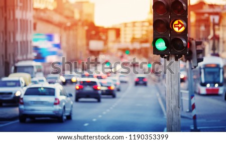 Cars moving on the road in city in late evening. View to the traffic with trafficlights and transport Royalty-Free Stock Photo #1190353399