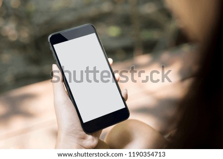 Smart phone on hand of women with white screen