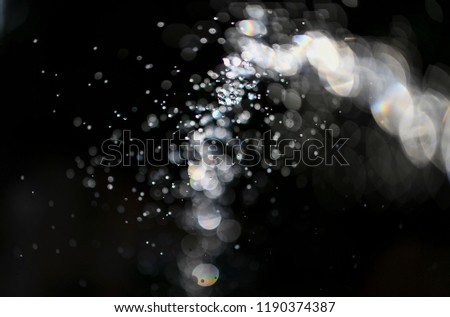 Abstract image of a hose being used to water a garden