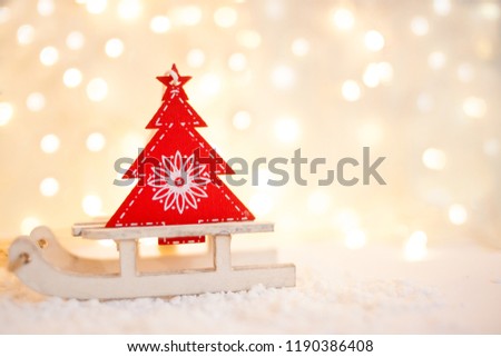 gift card with a new year and christmas with a picture of a snowman with a sleigh against a backdrop of glowing garlands