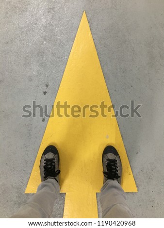 Yellow arrow on the floor