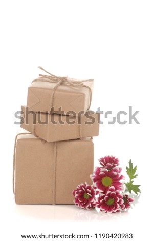 Autumn chrysanthemum flowers and gifts in kraft paper on white isolated background