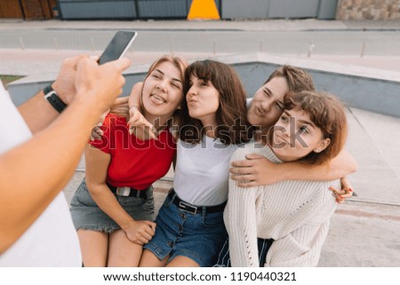 Best friends taking selfie outdoors with backlighting - Happy friendship concept with teenagers having fun together.