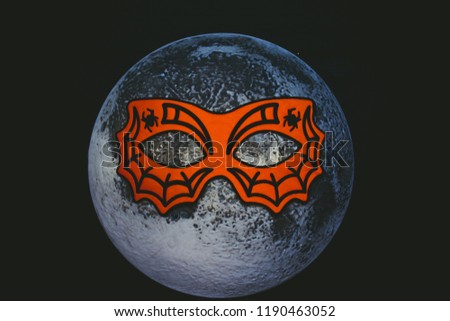 Moon in the mask of a spider. Night of Halloween. The moon wore a mask.