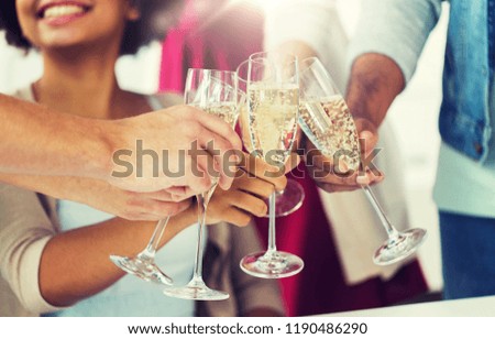 celebration, people and holidays concept - close up of happy friends clinking glasses of champagne at party Royalty-Free Stock Photo #1190486290