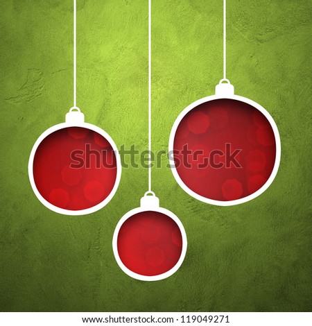 Hole cut in grunge wall to form christmas ball on red bokeh light background