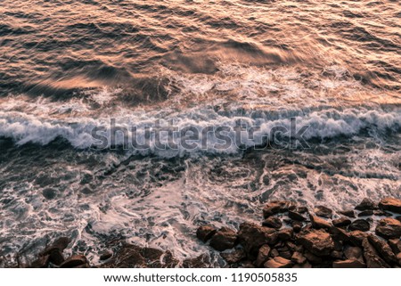Waves Breaking on the rocks during golden hour